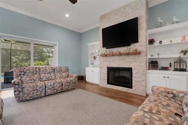 a living room with furniture a flat screen tv and a fireplace