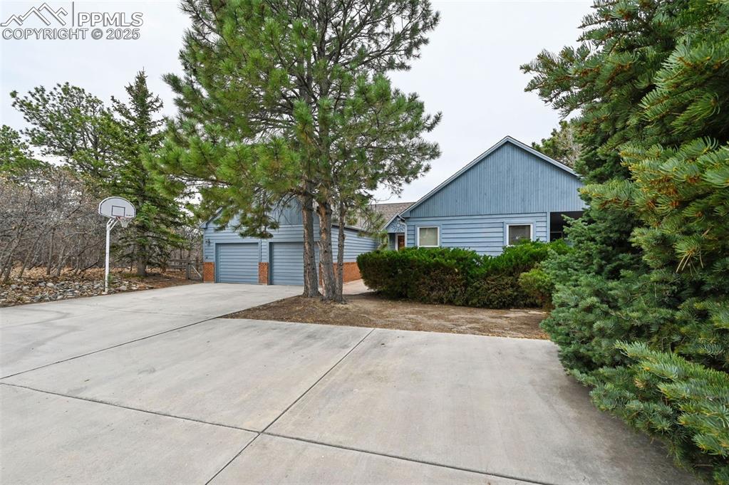 17580 Chipped Arrow Way Monument, CO 80132 - Photo 2 of 50 a front view of a house with a yard and trees