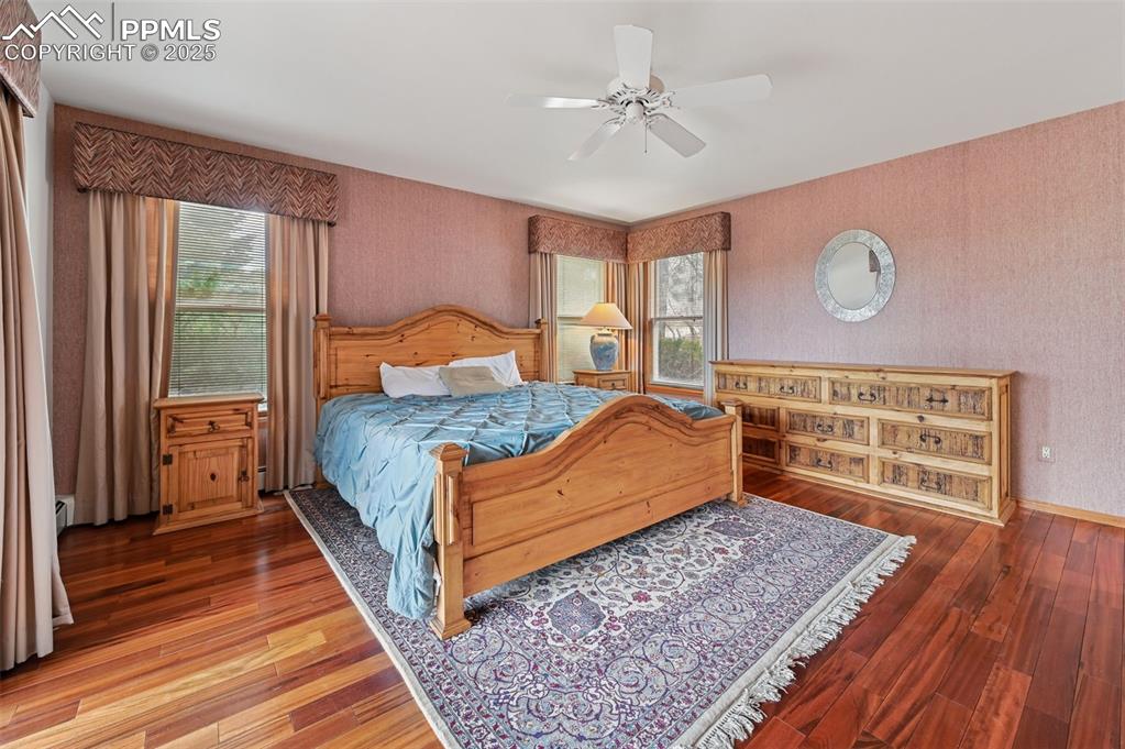 17580 Chipped Arrow Way Monument, CO 80132 - Photo 29 of 50 a bedroom with a bed and wooden floor