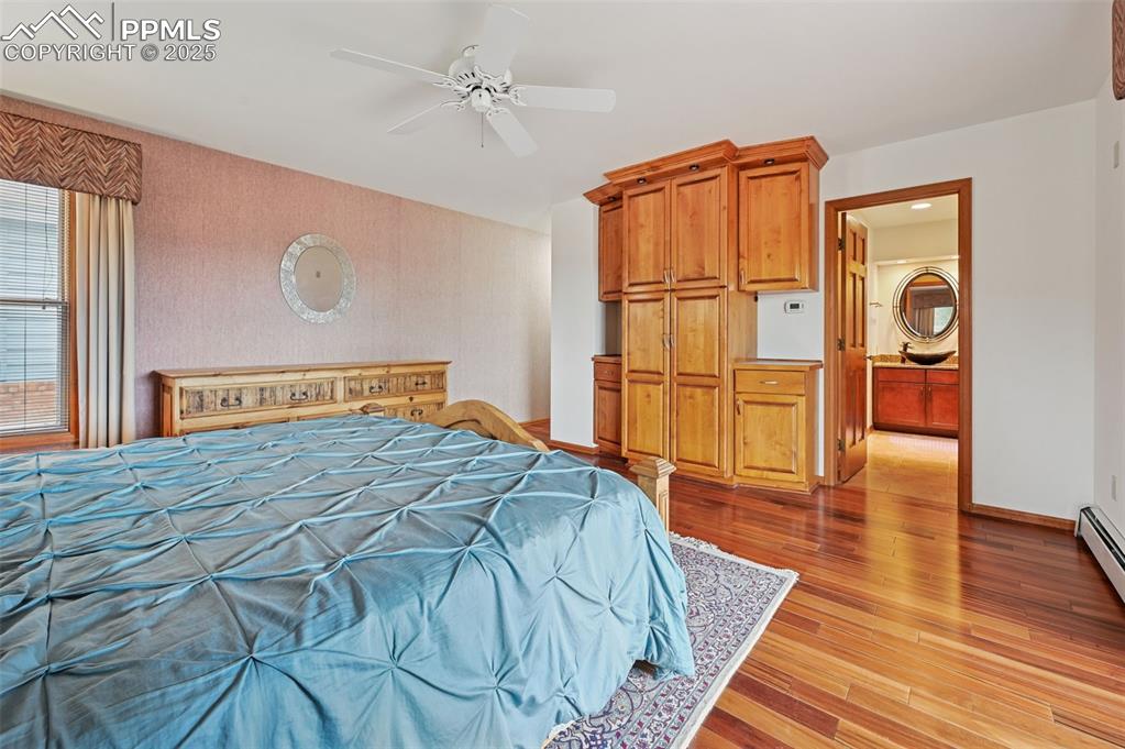 17580 Chipped Arrow Way Monument, CO 80132 - Photo 31 of 50 a bedroom with a bed and wooden floor