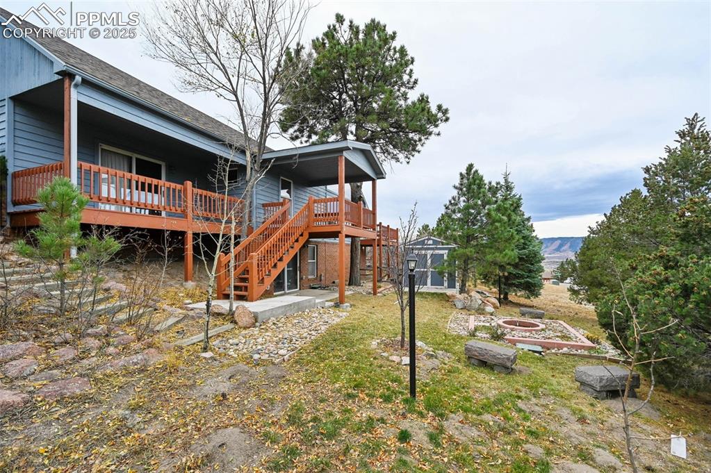 17580 Chipped Arrow Way Monument, CO 80132 - Photo 5 of 50 a backyard of a house with barbeque oven table and chairs