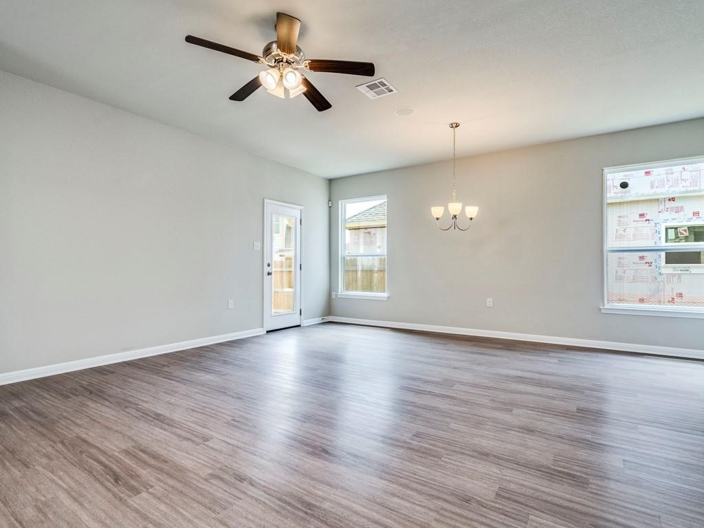 4210 Birdwatch Loop, Unit 2 Pflugerville, TX 78660 - Photo 5 of 31 An open living area showcases durable vinyl plank flooring and abundant natural light.