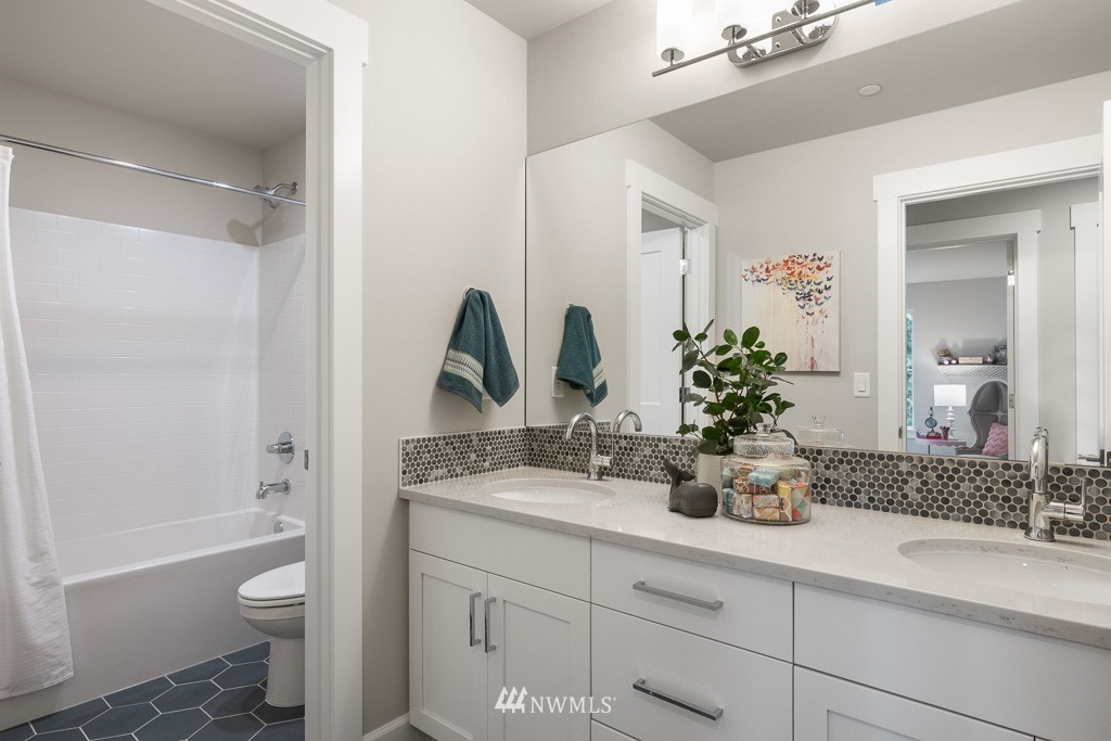 19037 85th ( 4) Avenue Bothell, WA 98011 - Photo 22 of 30 a bathroom with a granite countertop sink a toilet and a large mirror