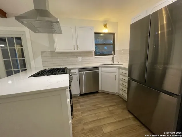 a kitchen with a refrigerator sink and stove