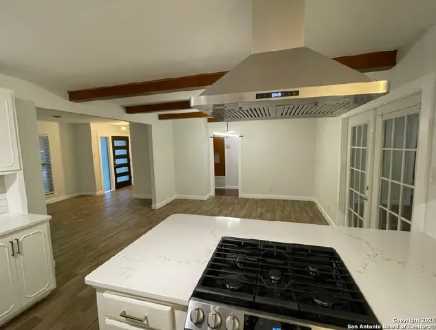 a large kitchen with a lot of counter space and stainless steel appliances
