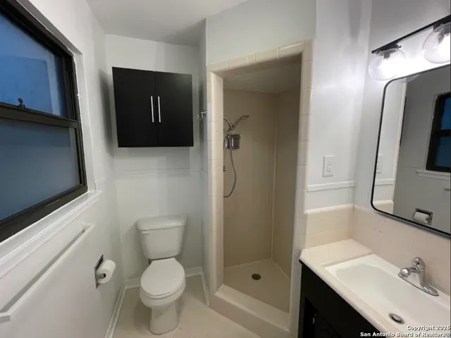 an empty room with a chandelier fan