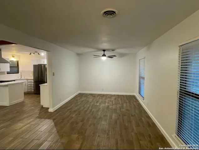 a view of a kitchen with a sink and refrigerator