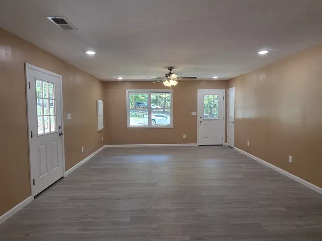 an empty room with windows and closet