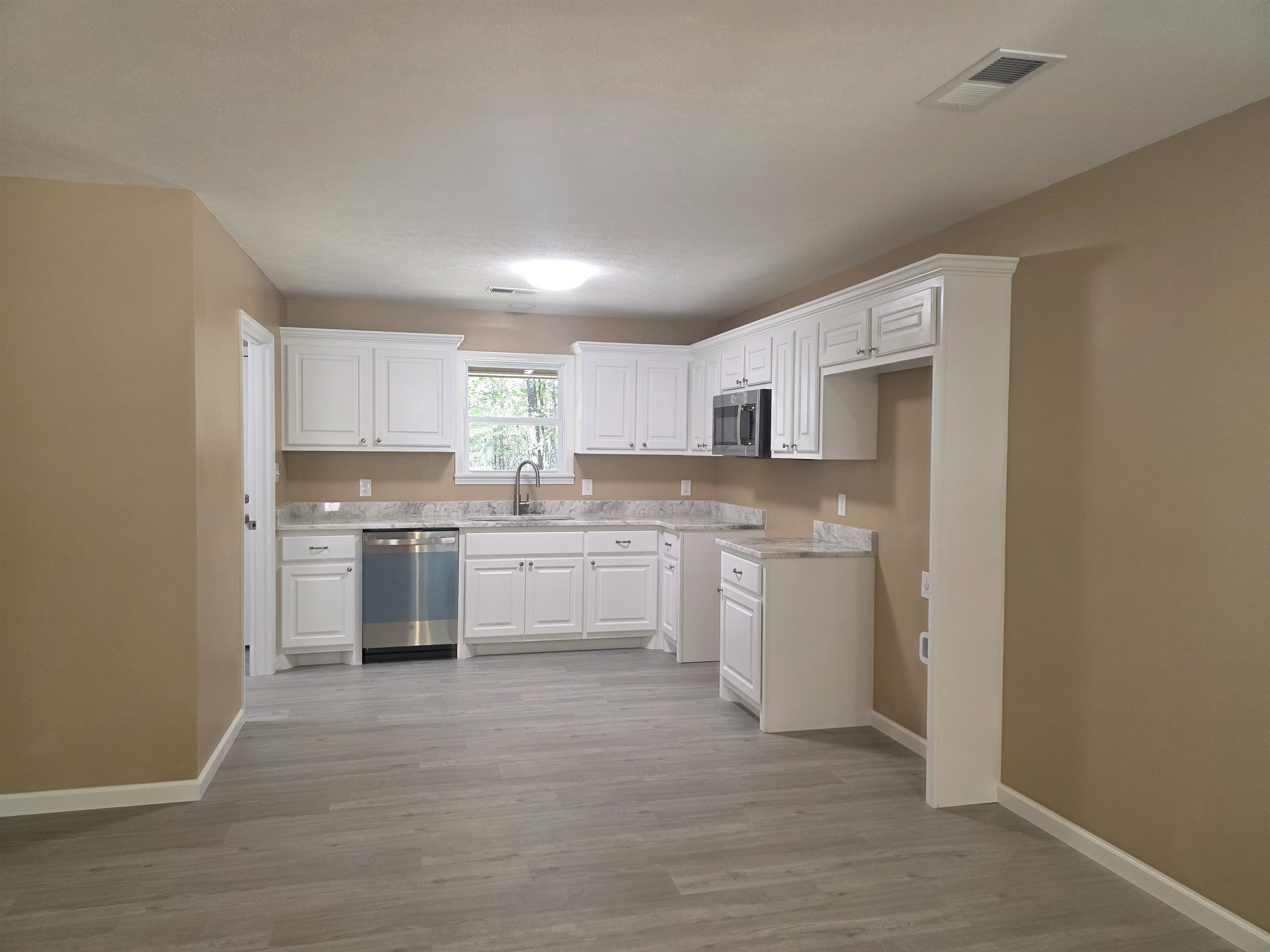 1020 Jade Road Savannah, TN 38372 - Photo 4 of 16 a kitchen with a white cabinets and white appliances