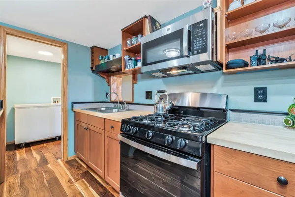a kitchen with stainless steel appliances granite countertop a stove and a sink