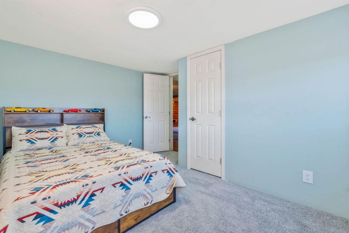 2005 County Road 207 Craig, CO 81625 - Photo 27 of 38 a bedroom with a bed and a painting on the wall
