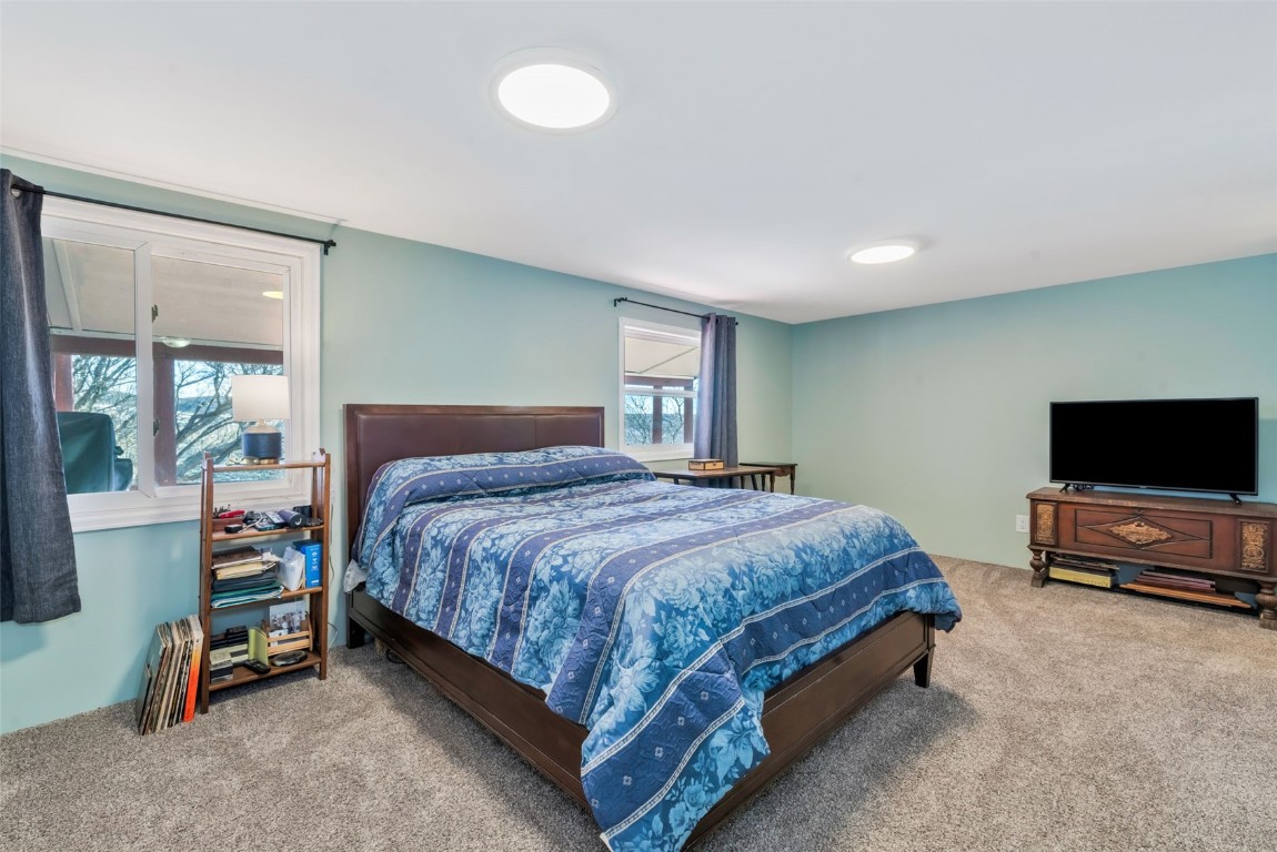 2005 County Road 207 Craig, CO 81625 - Photo 28 of 38 a spacious bedroom with a bed and a flat screen tv