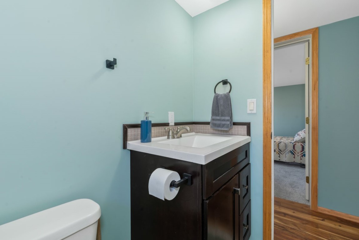 2005 County Road 207 Craig, CO 81625 - Photo 31 of 38 a bathroom with a granite countertop sink a toilet and a mirror