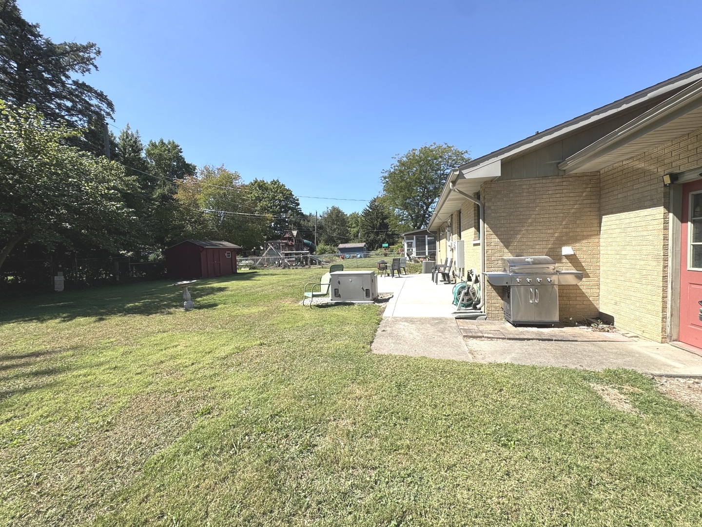 1442 West Budd Boulevard Kankakee, IL 60901 - Photo 19 of 27 a front view of a house with a yard