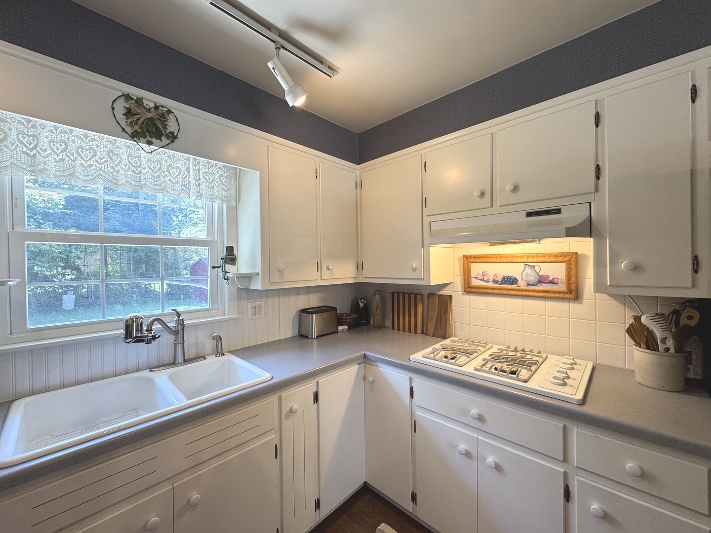 1442 West Budd Boulevard Kankakee, IL 60901 - Photo 6 of 27 a kitchen with stainless steel appliances a sink a stove and white cabinets