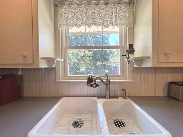 a bath tub sitting in a bathroom next to a window