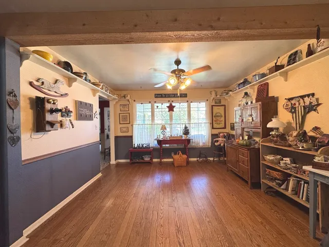 a living room with lots of furniture and a wooden floor