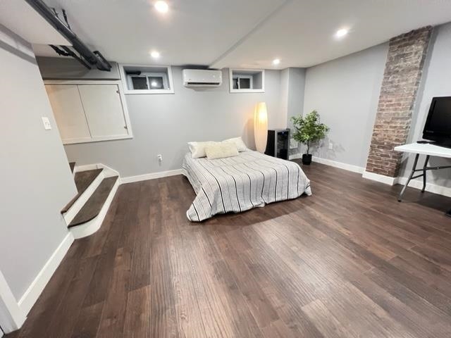 128 69th Street, Unit 1 Guttenberg, NJ 07093 - Photo 12 of 14 a spacious bedroom with a bed and a chair