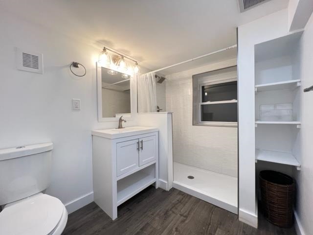 128 69th Street, Unit 1 Guttenberg, NJ 07093 - Photo 13 of 14 a bathroom with a sink a toilet and shower