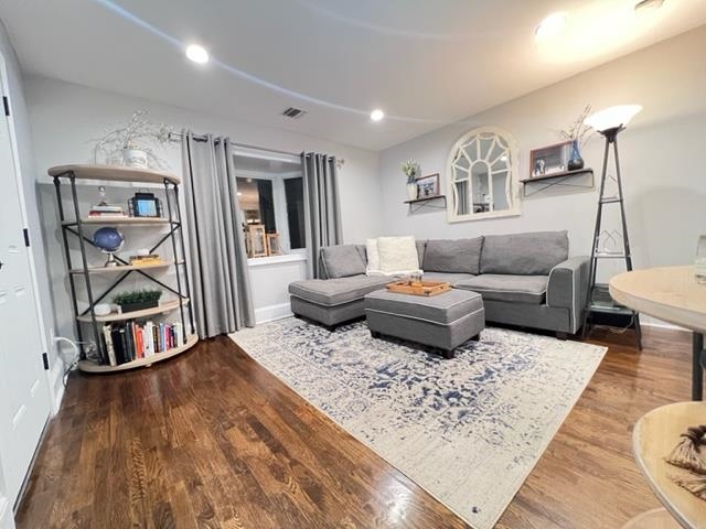 128 69th Street, Unit 1 Guttenberg, NJ 07093 - Photo 3 of 14 a living room with furniture and a wooden floor