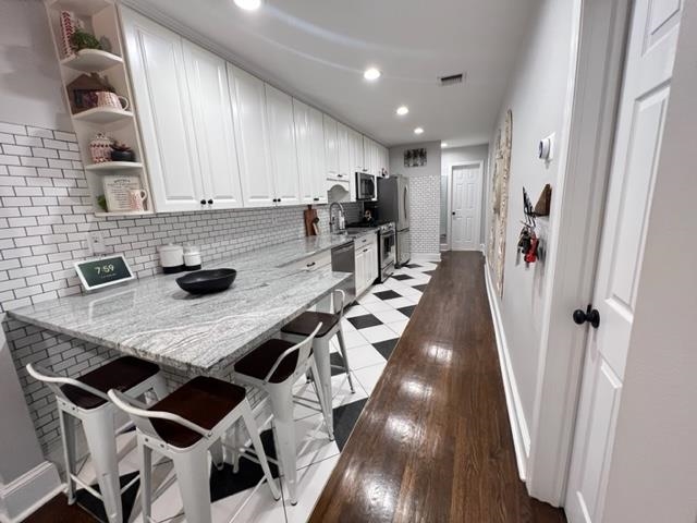128 69th Street, Unit 1 Guttenberg, NJ 07093 - Photo 5 of 14 a kitchen with furniture wooden floor and a counter top space