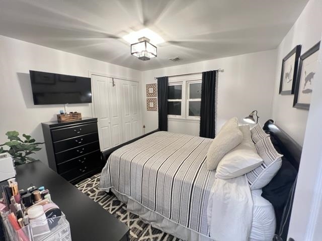 128 69th Street, Unit 1 Guttenberg, NJ 07093 - Photo 7 of 14 a bedroom with a bed and flat screen tv