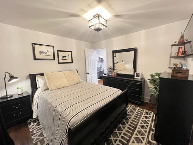 128 69th Street, Unit 1 Guttenberg, NJ 07093 - Photo 8 of 14 a bedroom with a bed and a chandelier