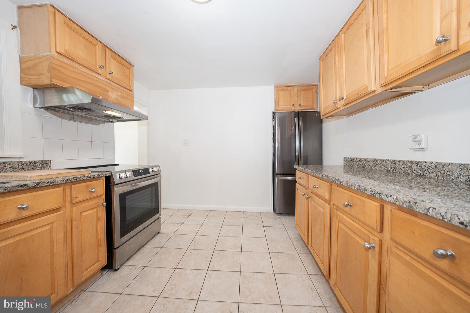 332 Old Lancaster Road Devon, PA 19333 - Photo 6 of 28 a kitchen with stainless steel appliances granite countertop a refrigerator and a stove