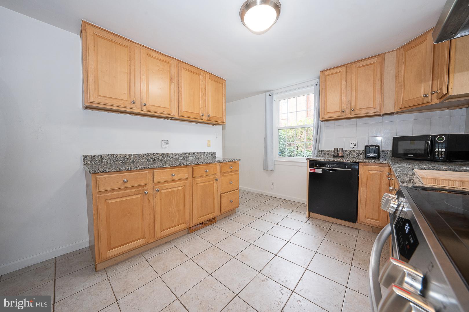 332 Old Lancaster Road Devon, PA 19333 - Photo 8 of 28 a kitchen with stainless steel appliances granite countertop a stove sink and cabinets