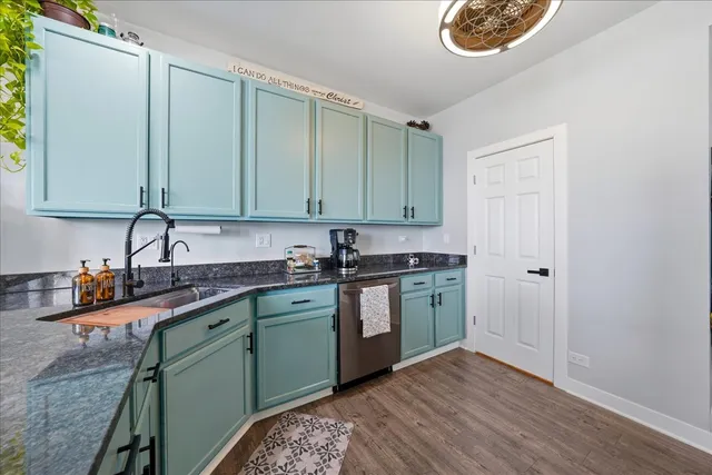 a kitchen with stainless steel appliances granite countertop a sink and cabinets