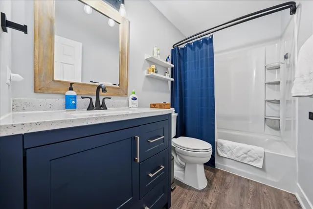 a bathroom with a sink toilet vanity and shower
