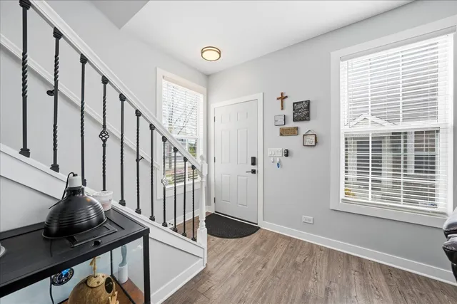a view of an entryway with wooden floor and windows
