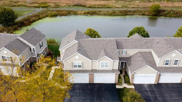 an aerial view of a house with a lake view
