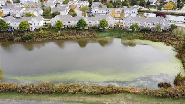 an aerial view of residential building with outdoor space and lake view