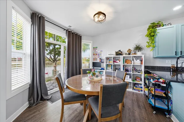 a dining room with furniture and a book shelf