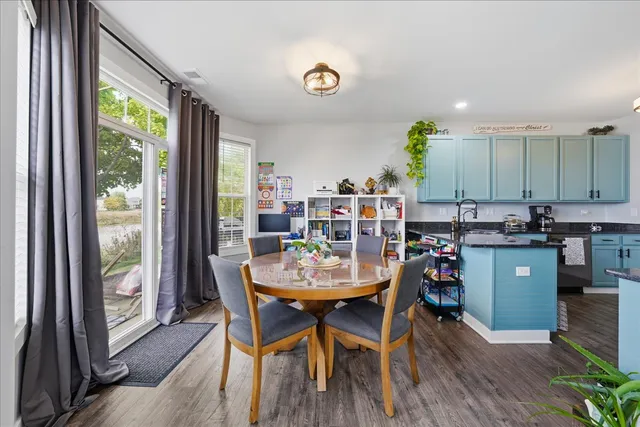 a view of a dining room with furniture and a window