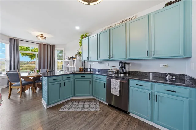a kitchen with cabinets a sink and appliances