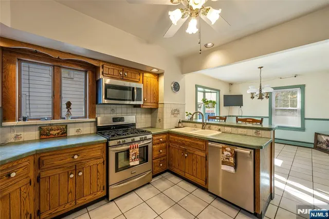 a kitchen with stainless steel appliances granite countertop a stove and a sink
