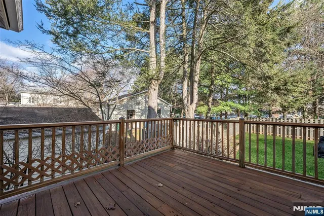 a balcony with wooden floor and fence
