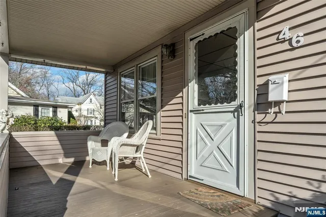 a view of a patio with a table and chairs and wooden floor