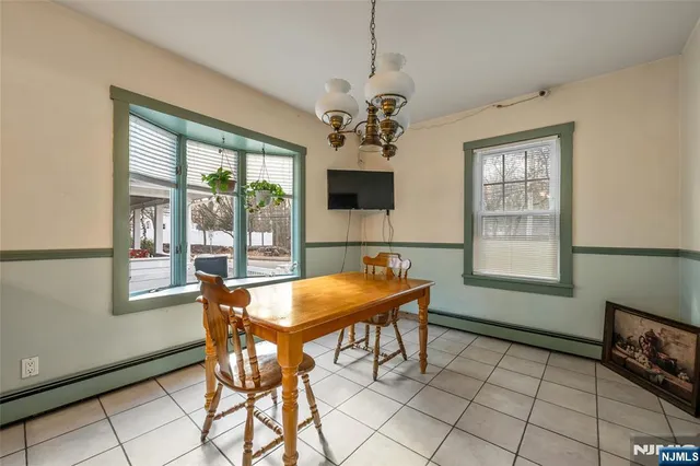 a dining room with furniture and window