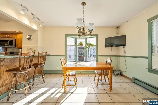a dining room with furniture and wooden floor
