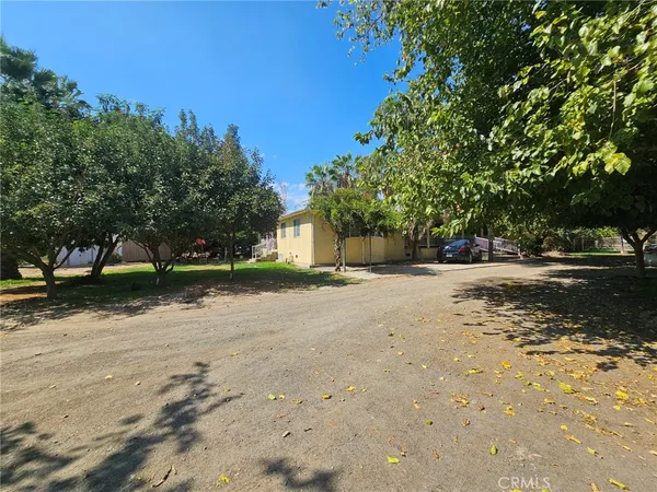 a backyard of a house with barbeque oven table and chairs