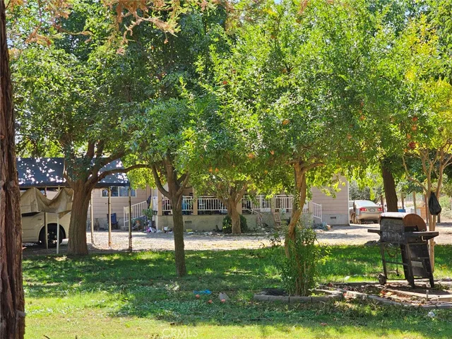a view of a house with garden and trees