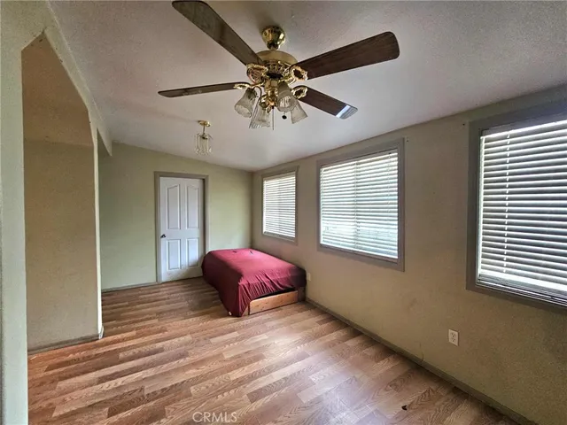 a spacious bedroom with a large bed a couch and dresser
