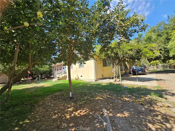 a view of a house with a yard and sitting area