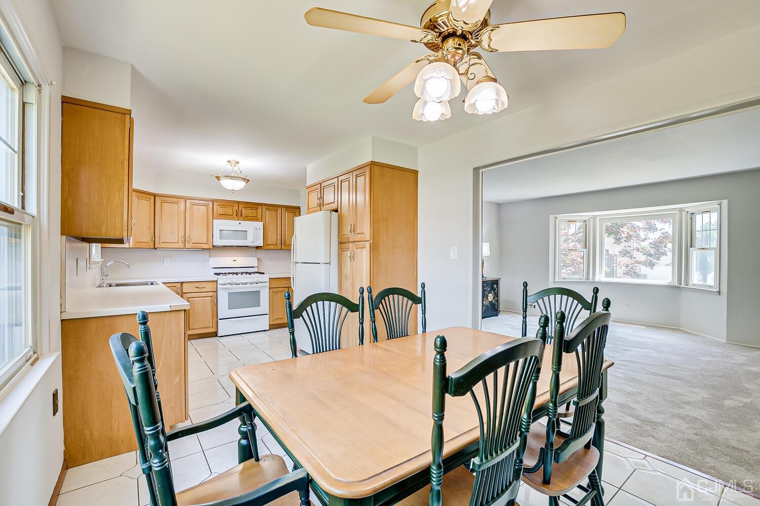 8 Meyer Road Edison, NJ 08817 - Photo 18 of 47 a view of a dining room with furniture and chandelier
