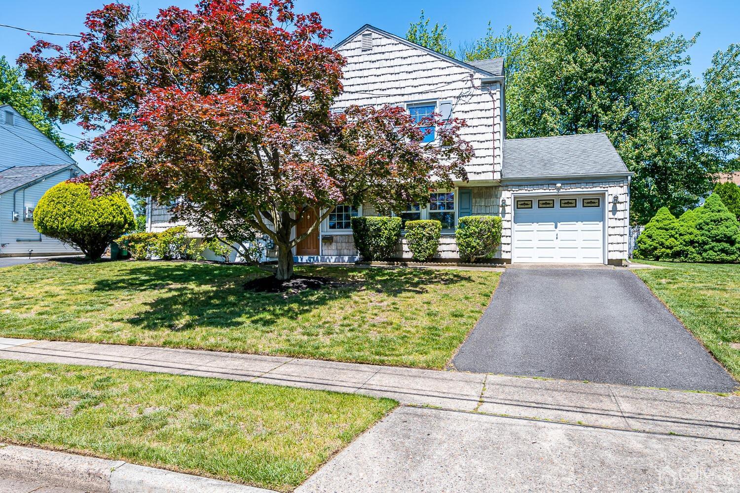 8 Meyer Road Edison, NJ 08817 - Photo 44 of 47 a front view of a house with a yard and a garage