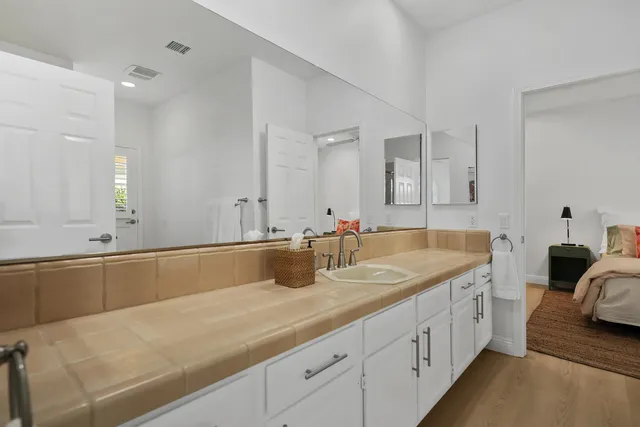 a bathroom with a granite countertop sink and a mirror