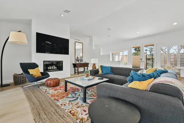 a living room with furniture fireplace and a flat screen tv